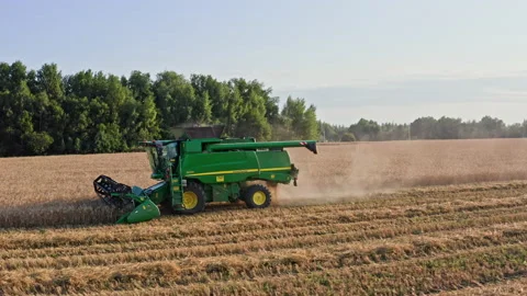 Drone Video - Tracking Shot Of Wheat Harvesting with a John Deere Combine Stock Footage 172524215