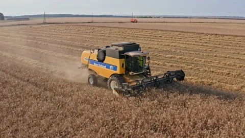 Drone Video - Tracking Shot Of Wheat Harvesting with a New Holland Combine Stock Footage 172524352