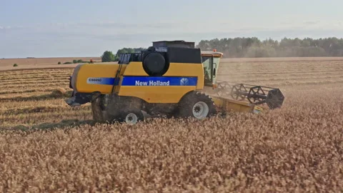 Drone Video - Tracking Shot Of Wheat Harvesting with a New Holland Combine Stock Footage 172524403