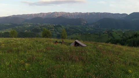 Drone video with two mountain bicycles and a tent on a mountain meadow 스톡 동영상 113205525