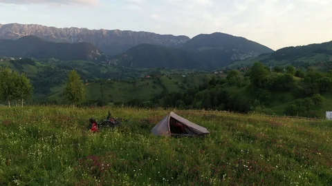 Drone video with two mountain bicycles and a tent on a mountain meadow 스톡 동영상 113205793