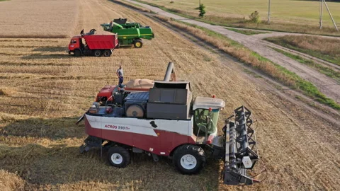 Drone Video - Unloading the Acros 590 combine into a dump truck Stock Footage 172529136