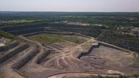 Drone video of vast terraced stone quarry with heavy mining machinery Stock Footage 343134450