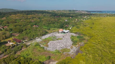 Drone video of waste management, garbage dump on Nusa Lembongan island near Bali Stock Footage 316668199