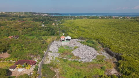 Drone video of waste management, garbage dump on Nusa Lembongan island near Bali Stock Footage 316668275