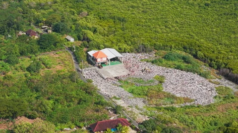 Drone video of waste management, garbage dump on Nusa Lembongan island near Bali Stock Footage 316668535