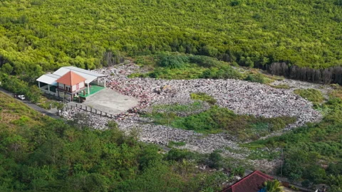 Drone video of waste management, garbage dump on Nusa Lembongan island near Bali Stock Footage 316668750