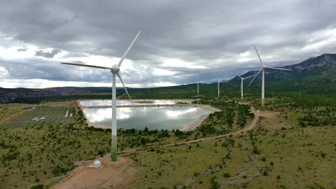 Drone video of Wind Turbines Turning on a Mountain with a Sky Background. 動画素材 336361211