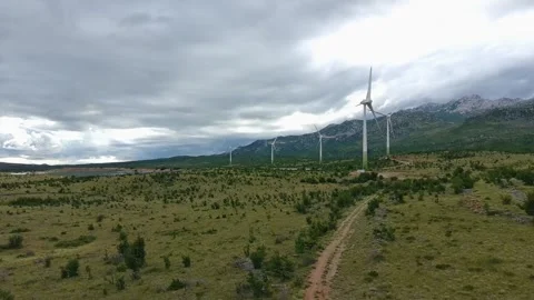 Drone video of Wind Turbines Turning on a Mountain with a Sky Background. 動画素材 336361220