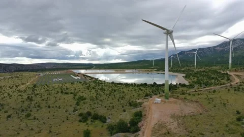 Drone video of Wind Turbines Turning on a Mountain with a Sky Background. 動画素材 336361228