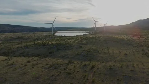 Drone video of Wind Turbines Turning on a Mountain with a Sky Background. 動画素材 336361422