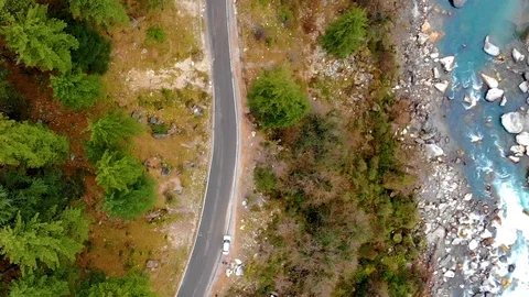 Drone video winding road in forest car moving and blue river on the side Stock Footage 110206752
