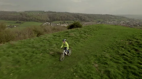 Drone video of a young boy riding his bike in a field. Stock Footage 239915934