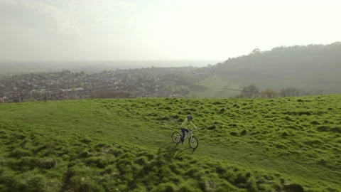 Drone video of a young boy riding his bike in a field. Stock Footage 239916019