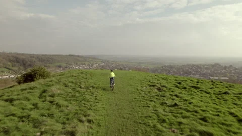 Drone video of a young boy riding his bike in a field. Stock Footage 239916623