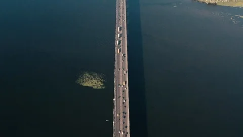 Drone view 4K Flying right above the bridge over which the cars are traveling Stock Footage 111876854