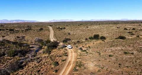 Drone View of 4x4 Vehicle Crossing a River in the Great Karoo, South Africa Stock Footage 341346431