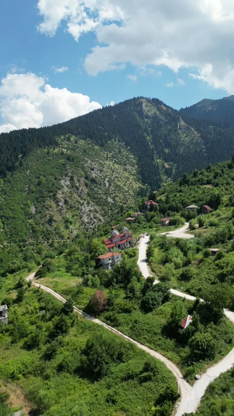 Drone view of abandoned leaning Panagia Theotokou church damaged by landslide Stock Footage 339433852