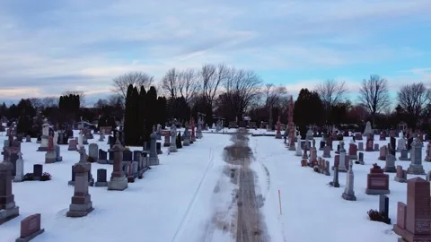 Drone view  above the cemetery in winter daytime there are several tombstones HD Stock Footage 204822761