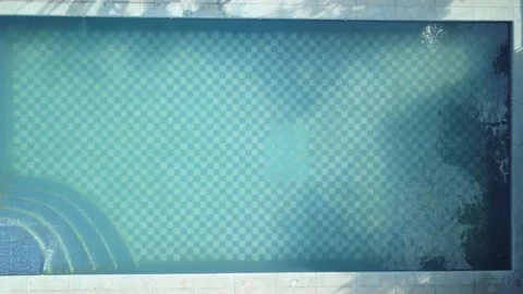 Drone view from above of several friends jumping into the pool filled with water 스톡 동영상 161964237