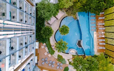 Drone view from above at swimming pool, couple men and women in swimming pool Fotos Stock
