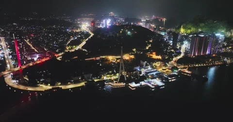 Drone view, Aerial view of Bai Chay bridge at night in Ha Long City, Vietnam Stock Footage 296853898