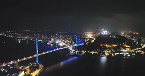 Drone view, Aerial view of Bai Chay bridge at night in Ha Long City, Vietnam Stock Footage 296854203