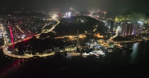 Drone view, Aerial view of Bai Chay bridge at night in Ha Long City, Vietnam Stock Footage 296854284
