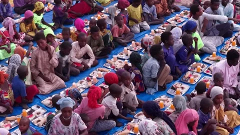 Drone view of African children eating at iftar during Ramadan, April 25, 2026, Video stock 334802952