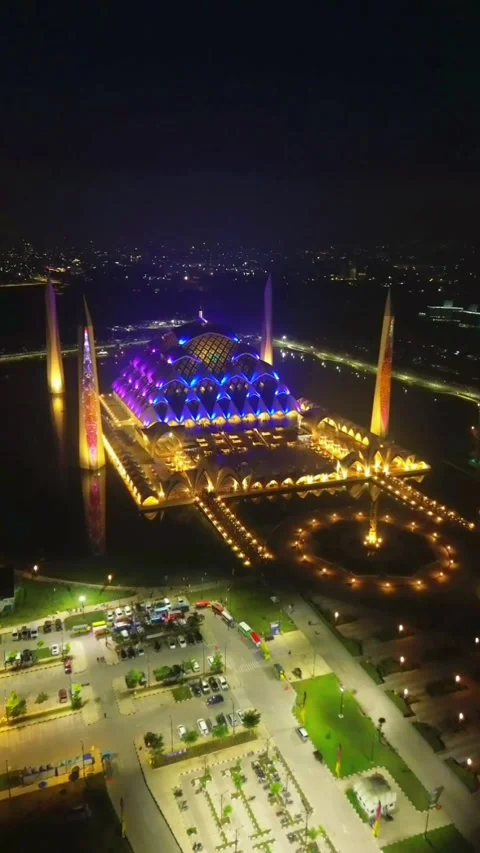 Drone view of Al-Jabbar mosque in the night with city lights. Stock Footage 277517093