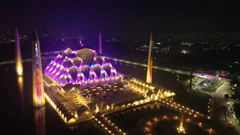 Drone view of Al-Jabbar mosque in the night with city lights. Stock Footage 277517098