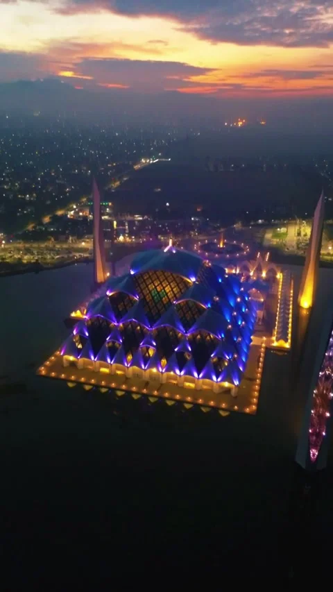 Drone view of Al-Jabbar mosque in the night with city lights. Stock Footage 277520596