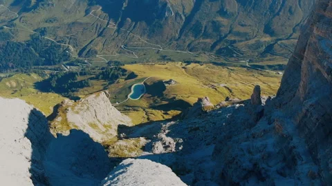 Drone view of alpine lake and winding roads in the Dolomites near Piz Boè Stock Footage 312271537
