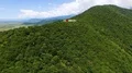 Drone view of amazing mountain hill with art installation on peak, nature 4k or 4k+ Resolution