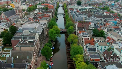 Drone View of Amsterdam Cityscape with Landmarks, Rooftops, and Canal District Stock Footage 312763685