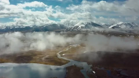 Drone View of Arabel Plateau Lakes with Greenery and Snowy Mountains in Kyrgyzst Stock Footage 306573397