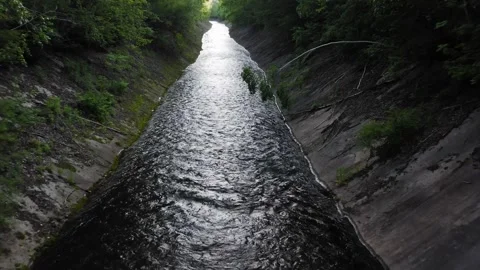 Drone view of an artificial canal in a green forest channel walls reinforced 스톡 동영상 279985236