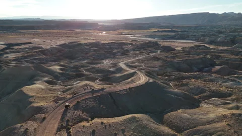 Drone View of ATV Vehicle Moving on Desert Road in Utah USA, Factory Butte Area Stock Footage 346214102