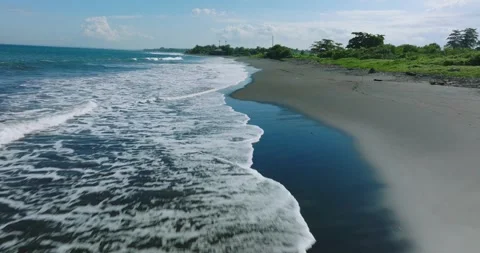 Drone view of Bali. Top view of wave on Keramas beach with black sand Stockbeeldmateriaal 241666787