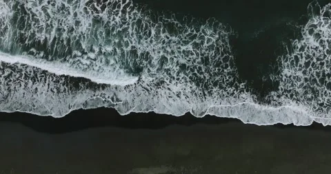 Drone view of Bali. Top view of wave on Keramas beach with black sand Stockbeeldmateriaal 242076262