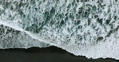 Drone view of Bali. Top view of wave on Keramas beach with black sand Stockbeeldmateriaal 242831136