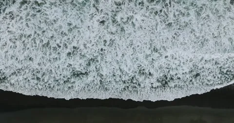Drone view of Bali. Top view of wave on Keramas beach with black sand 스톡 동영상 243623104