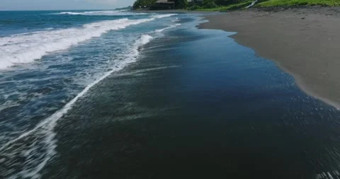 Drone view of Bali. Top view of wave on Keramas beach with black sand Stock Footage 243877728