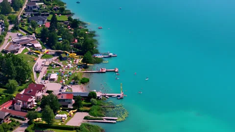 Drone view of the bay of faak's lake in Austria with people enjoying the beach 스톡 동영상 263142658