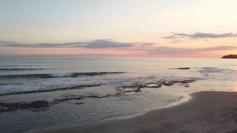 Drone view of the beach from above as the sun goes down Stock Footage 227443498