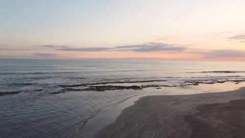 Drone view of the beach from above as the sun goes down Stock Footage 227445074