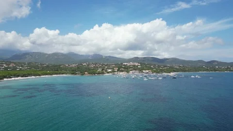 Drone View Of Beach And Turquoise Sea Corsica Hills in Background Video stock 220653508
