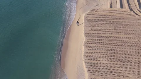 Drone view of beach with patterns of sunbeds and sea Stock-Footage 332129262