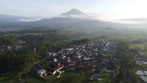 Drone view of the beautiful city under the mountain with the green landscape Stock Footage 167269726