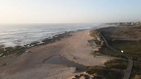 Drone view of a beautiful sandy beach large stones, wooden bridges and paths Stock Footage 254630142